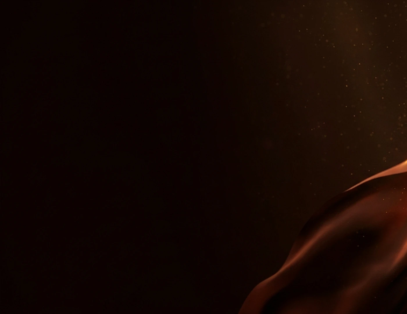 A dark brown silk fabric with subtle sparkling particles provides a rich background.